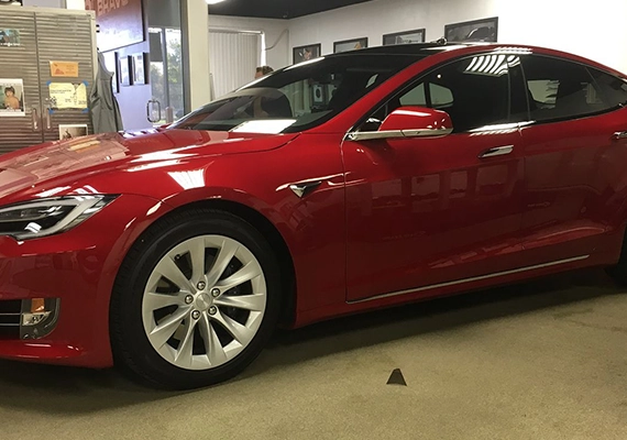 Red tesla with window tint
